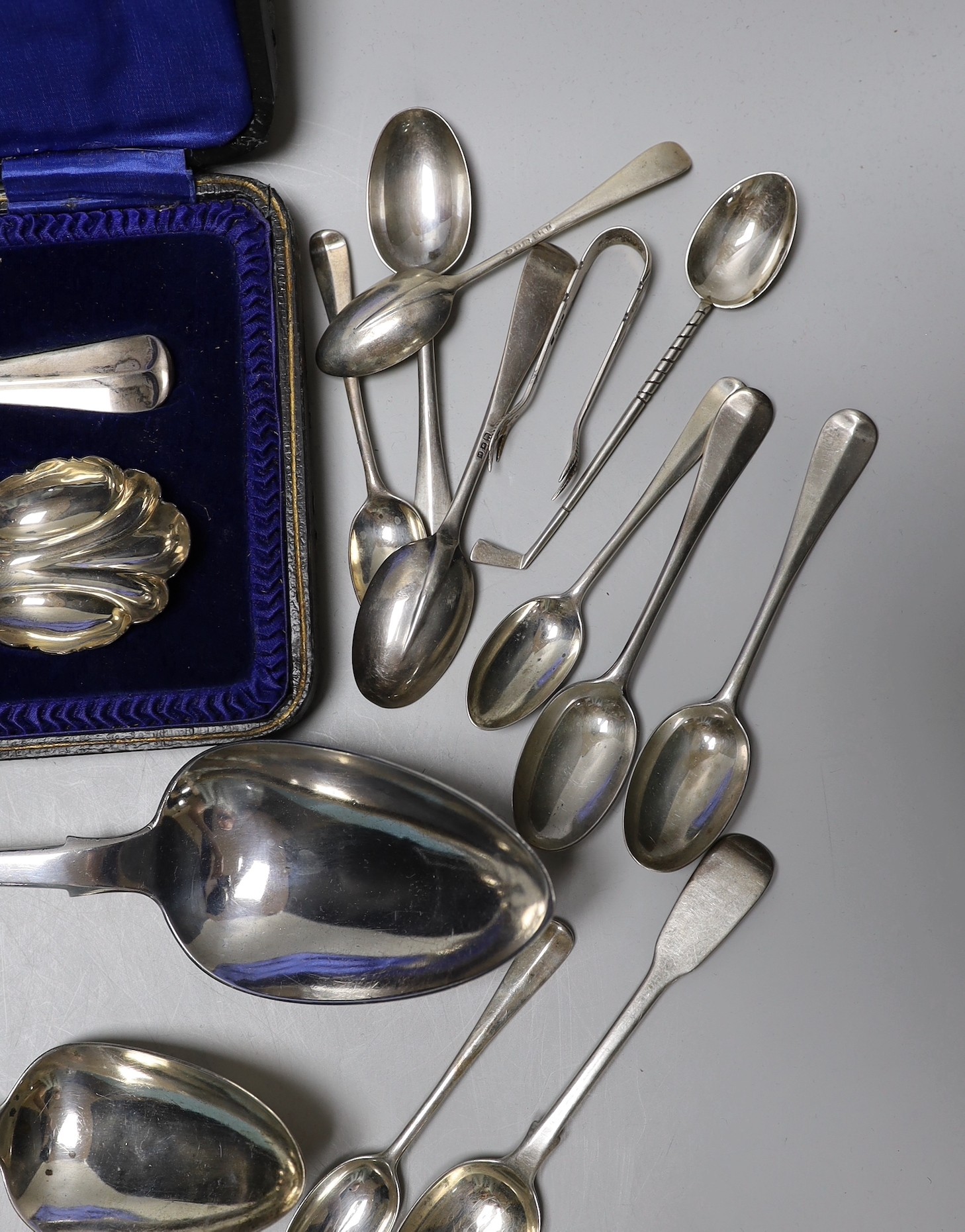 A Victorian Irish silver fiddle pattern basting spoon, Dublin, 1844, three George III tablespoons, a pair of later cased serving spoons and sundry tea, coffee and golf spoons, 23.7oz.